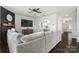 Open-concept living room with dark wood floors, fireplace, TV, and view to dining area at 17231 Rider Wood Ln, Charlotte, NC 28278