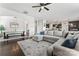 Spacious living room with a large sectional sofa, dark wood floors, an open layout, and a view of the dining area at 17231 Rider Wood Ln, Charlotte, NC 28278