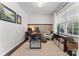 Cozy home office with a dark wood desk, comfortable chair, natural light, and stylish decor, perfect for remote work at 17231 Rider Wood Ln, Charlotte, NC 28278