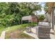 Private backyard with a patio, pergola, and lush landscaping at 1825 Evergreen Dr, Charlotte, NC 28208