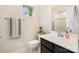 Well-lit powder room with a vanity, toilet, and decorative towel rack at 1825 Evergreen Dr, Charlotte, NC 28208