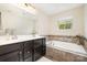 Bathroom features double sink vanity, tile floor, and soaking tub at 1825 Evergreen Dr, Charlotte, NC 28208