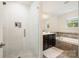 Bright bathroom featuring a glass-enclosed shower and a separate soaking tub at 1825 Evergreen Dr, Charlotte, NC 28208