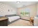 Neutral bedroom with a daybed, star wallpaper, and natural light at 1825 Evergreen Dr, Charlotte, NC 28208