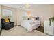 Comfortable bedroom with a ceiling fan, plush rug, and large window at 1825 Evergreen Dr, Charlotte, NC 28208