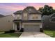 Charming two-story home with neutral siding, a two-car garage, and a well-manicured lawn at 1825 Evergreen Dr, Charlotte, NC 28208