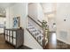 Foyer with staircase, artwork, and wood flooring creates a welcoming and stylish entrance at 1825 Evergreen Dr, Charlotte, NC 28208