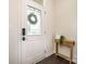 Bright and welcoming foyer featuring a white door with a decorative glass window and wood flooring at 1825 Evergreen Dr, Charlotte, NC 28208