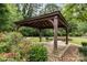 Picturesque gazebo surrounded by flowering shrubs and greenery in a park at 1825 Evergreen Dr, Charlotte, NC 28208