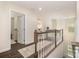 Hallway with wood floors, wood and white railing, and view of bedroom at 1825 Evergreen Dr, Charlotte, NC 28208