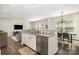 Kitchen with granite countertops, stainless steel dishwasher, bar seating, and open to living and dining areas at 1825 Evergreen Dr, Charlotte, NC 28208