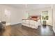 Main bedroom features wood floors, ceiling fan, and view of ensuite bath at 1825 Evergreen Dr, Charlotte, NC 28208