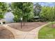 Scenic view of community greenspace with lush trees, path and gazebo at 1825 Evergreen Dr, Charlotte, NC 28208