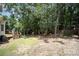 Large backyard with mature trees, lush grass, and a deck perfect for outdoor activities at 1846 Sam Smith Rd, Fort Mill, SC 29708