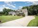 Spacious home with a long driveway, lush green lawn, and mature trees; perfect for Gathering living at 1846 Sam Smith Rd, Fort Mill, SC 29708