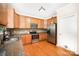 Spacious kitchen featuring wooden cabinets, granite countertops, stainless steel appliances, and ample lighting at 1846 Sam Smith Rd, Fort Mill, SC 29708
