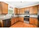 Well-lit kitchen with wooden cabinets, granite countertops, stainless steel appliances, and tile backsplash at 1846 Sam Smith Rd, Fort Mill, SC 29708