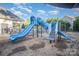 Community playground featuring a blue slide, stairs, and pea gravel safety ground cover at 1846 Sam Smith Rd, Fort Mill, SC 29708