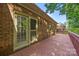 Exterior view of a wood back deck attached to a brick home with a yard at 212 Foxfield Ln, Matthews, NC 28105