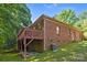 Brick home featuring an attached wood deck overlooking the large backyard at 212 Foxfield Ln, Matthews, NC 28105