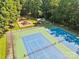Aerial view of community tennis courts and playground surrounded by lush greenery in a wooded setting at 212 Foxfield Ln, Matthews, NC 28105