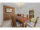 Elegant dining room boasts a brick accent wall, classic chandelier, and dining table at 212 Foxfield Ln, Matthews, NC 28105