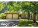 Charming brick home with a two-car garage surrounded by mature trees at 212 Foxfield Ln, Matthews, NC 28105