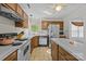 Efficient kitchen featuring wood cabinets, an island, and essential appliances at 212 Foxfield Ln, Matthews, NC 28105