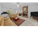 Inviting living room features a brick fireplace, neutral carpet and opens to dining area at 212 Foxfield Ln, Matthews, NC 28105