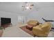 Spacious living room with a ceiling fan, neutral carpet, and ample natural light at 212 Foxfield Ln, Matthews, NC 28105