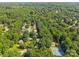 Aerial shot of a neighborhood surrounded by lush trees, showcasing tennis courts and community features at 212 Foxfield Ln, Matthews, NC 28105