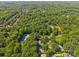 Overhead shot featuring a vibrant neighborhood, showcasing the tennis courts, mature trees and green landscapes at 212 Foxfield Ln, Matthews, NC 28105