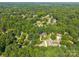 Aerial view showcasing the lush neighborhood with mature trees, manicured lawns and convenient, tree-lined streets at 212 Foxfield Ln, Matthews, NC 28105