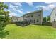 Spacious backyard featuring a deck, lush green lawn, and mature landscaping at 2240 Arbor Vista Dr, Charlotte, NC 28262