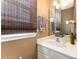 Bright bathroom featuring a white vanity, warm neutral paint, and bamboo shades at 2240 Arbor Vista Dr, Charlotte, NC 28262