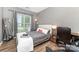 Relaxing bedroom with wood floors, large window, and neutral gray walls at 2240 Arbor Vista Dr, Charlotte, NC 28262