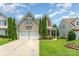Charming two-story home featuring a manicured lawn, attractive landscaping, and a two car garage at 2240 Arbor Vista Dr, Charlotte, NC 28262