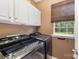 Convenient laundry room featuring modern washer and dryer, storage cabinets, and a window at 2240 Arbor Vista Dr, Charlotte, NC 28262