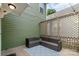 Inviting back patio featuring stylish wicker furniture, decorative string lights, and a privacy lattice wall at 2619 Merion Hills Ct, Charlotte, NC 28269
