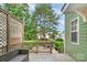 Relaxing backyard patio with seating, string lights, and a view of lush greenery and mature trees at 2619 Merion Hills Ct, Charlotte, NC 28269