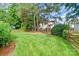Well-manicured backyard featuring green grass and a wooden fence at 2619 Merion Hills Ct, Charlotte, NC 28269