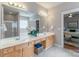 Bathroom featuring double sinks, a soaking tub and a standing shower at 2619 Merion Hills Ct, Charlotte, NC 28269