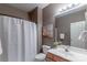 Neutral bathroom featuring a single sink, shower with curtain and decorative wall art at 2619 Merion Hills Ct, Charlotte, NC 28269