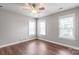 Bright bedroom with hard floors, ceiling fan, and windows providing natural light at 2619 Merion Hills Ct, Charlotte, NC 28269