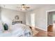 Well lit bedroom featuring an area rug, hard wood floors, a ceiling fan and ensuite bath at 2619 Merion Hills Ct, Charlotte, NC 28269