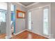 Bright foyer with hardwood floors, white trim, and a stylish mirror, offering a warm welcome at 2619 Merion Hills Ct, Charlotte, NC 28269