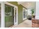 Welcoming front porch with green siding, brick accents, and ample space for outdoor seating at 2619 Merion Hills Ct, Charlotte, NC 28269