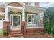 Charming front porch with brick columns, white railings, and a well-maintained landscaped entrance at 2619 Merion Hills Ct, Charlotte, NC 28269
