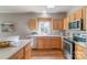 Bright kitchen with hardwood floors, light wood cabinetry, modern appliances, and ample counter space at 2619 Merion Hills Ct, Charlotte, NC 28269