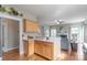 Open kitchen with a breakfast bar that leads into a living room with a fireplace at 2619 Merion Hills Ct, Charlotte, NC 28269